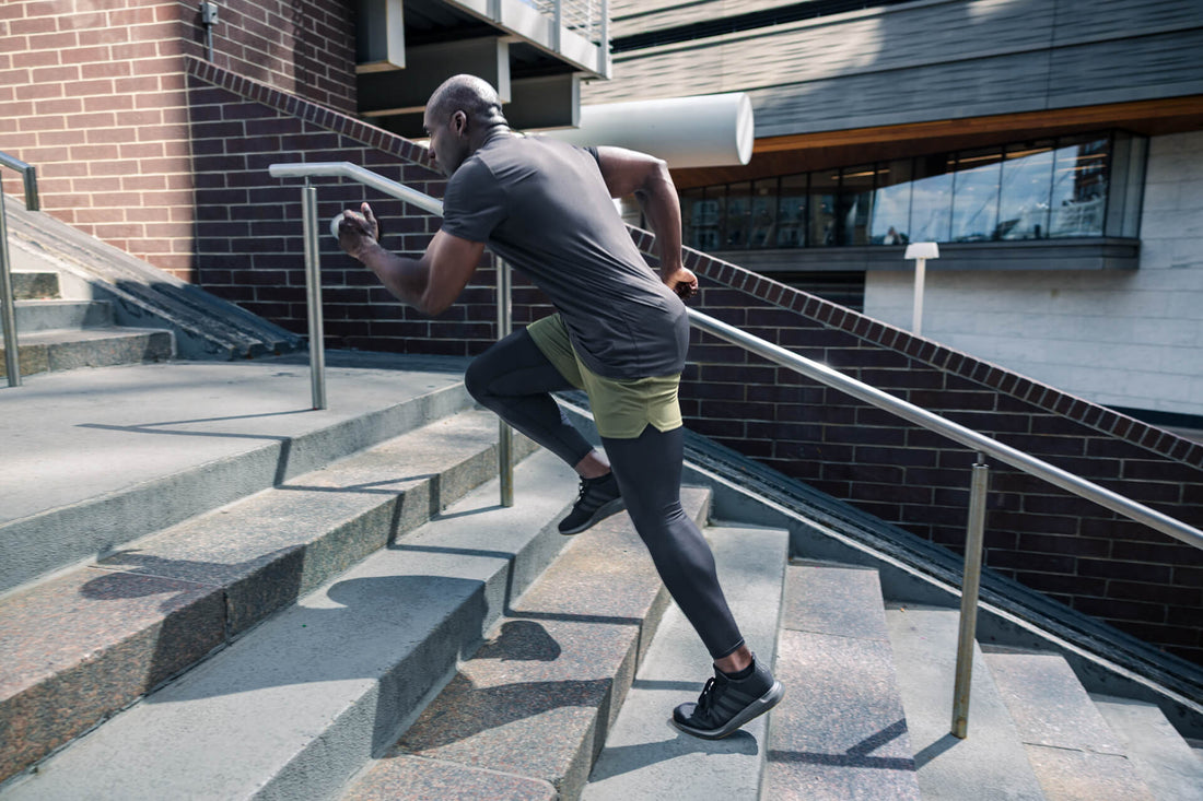 Athlete sprints up stairs in REP apparel.